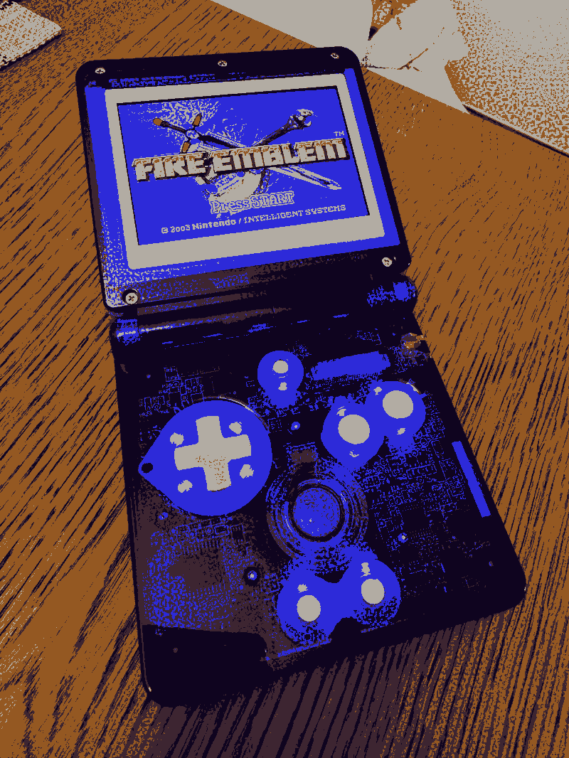 A GBA SP showing the Fire Emblem title screen with a transparent purple case and back lighting.