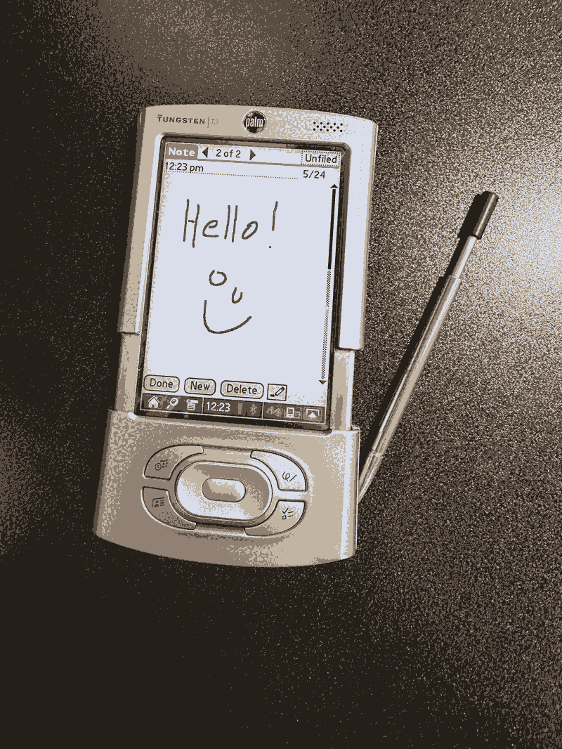 A Palm Pilot Tungsten T3 with Hello and a smiley face written on the screen