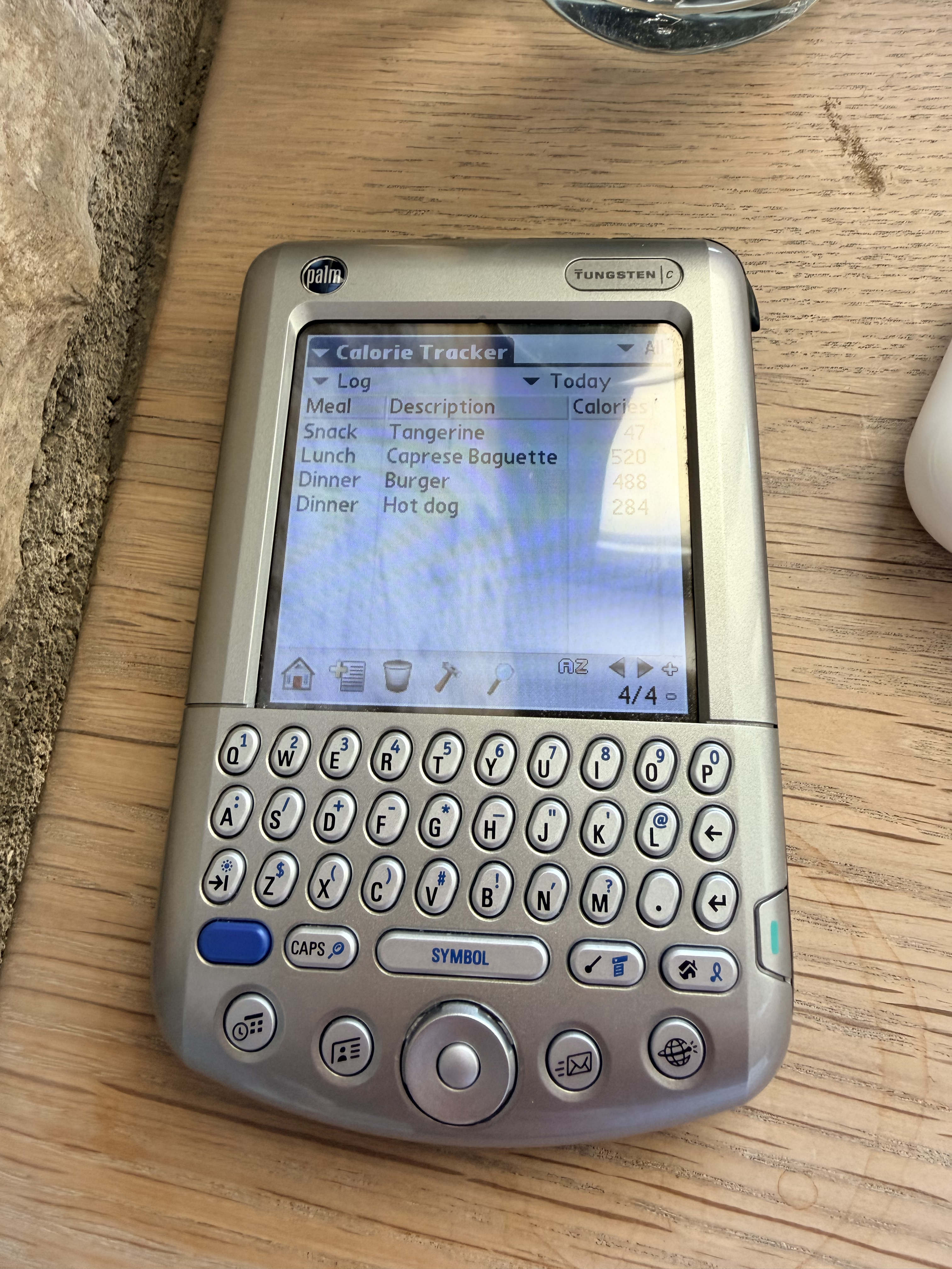 A Palm Pilot Tungsten C showing a list of food items