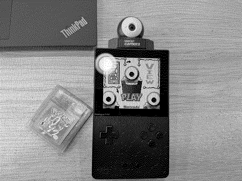 An Analogue Pocket with a Gameboy Camera cartridge next to a ThinkPad