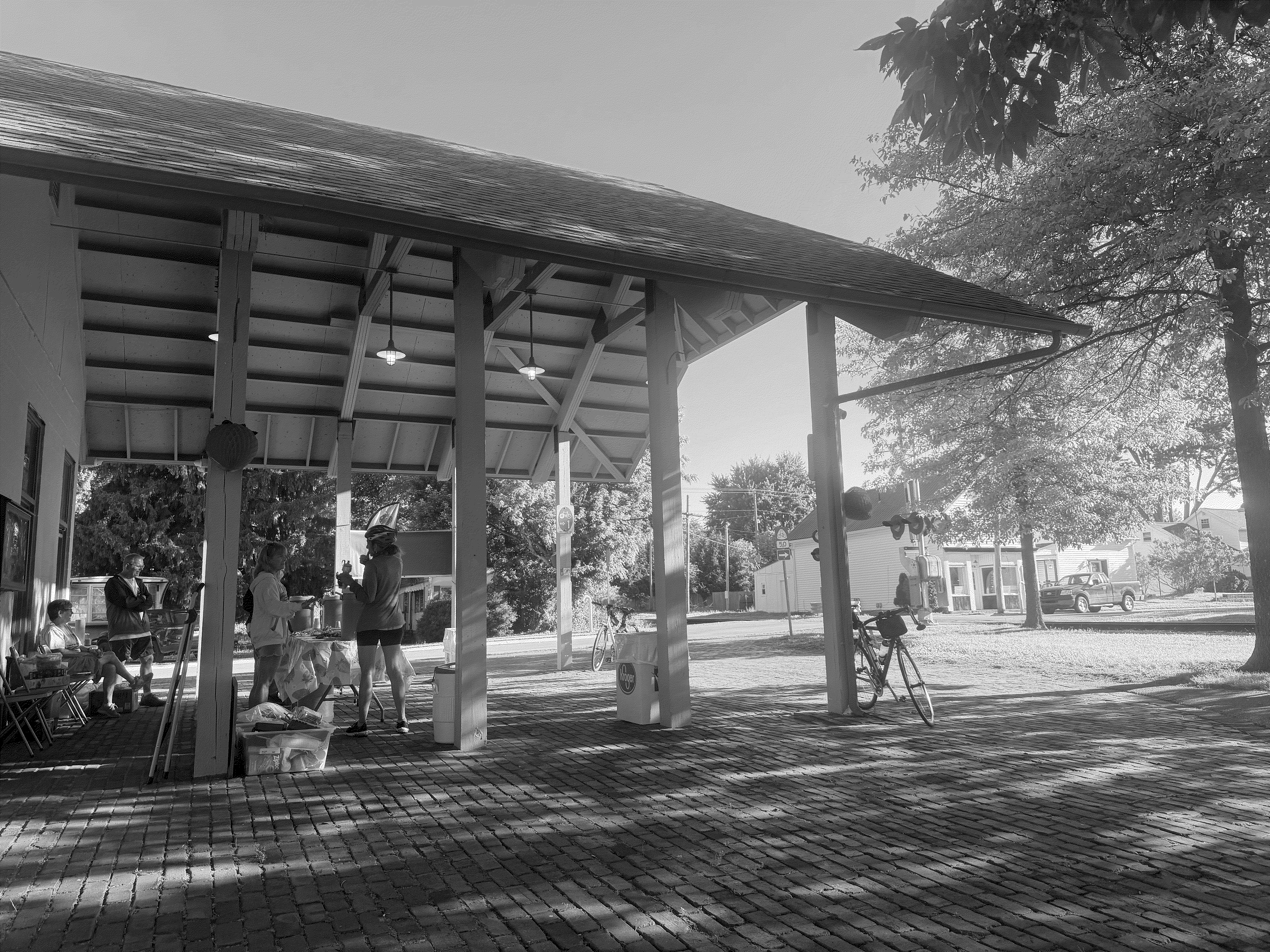 Park shelter with people giving out food